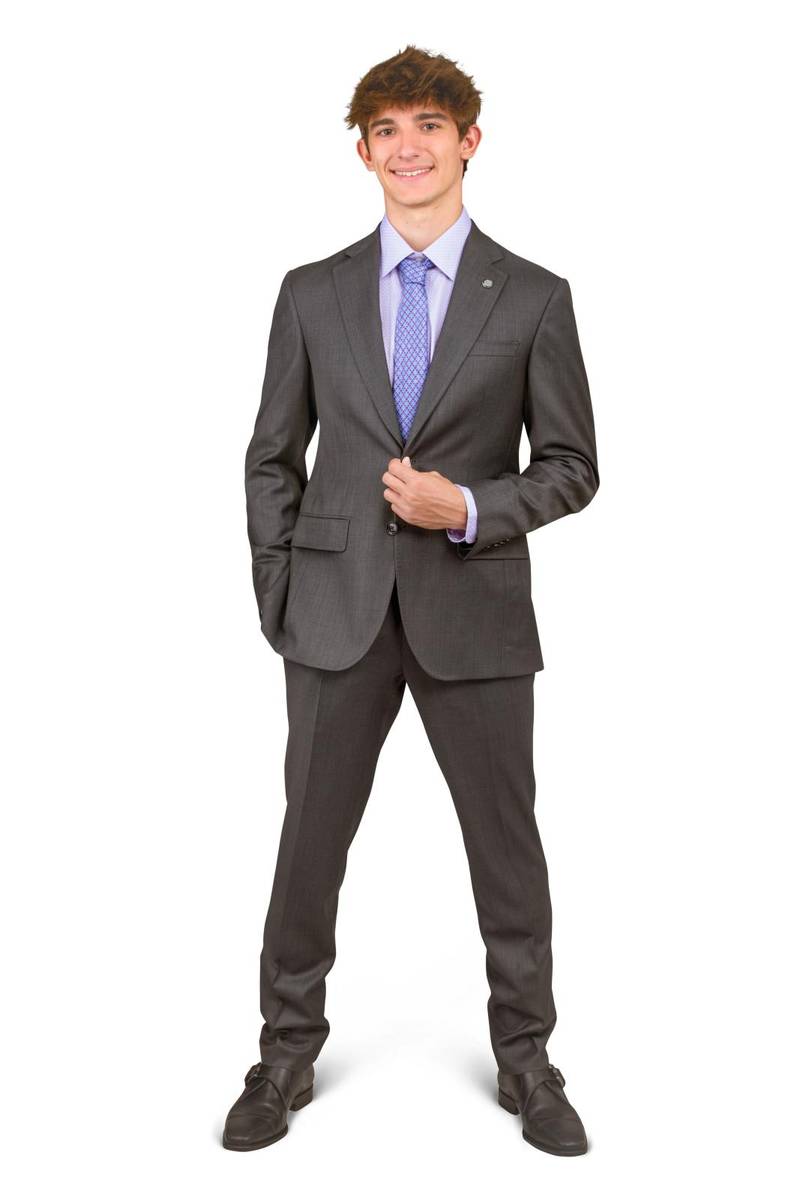 Studio portrait of school senior boy standing in a grey suit