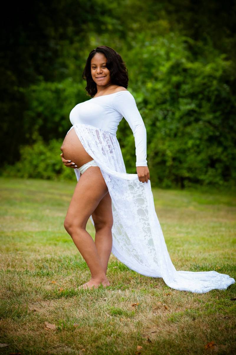 Pregnant woman in a white long dress