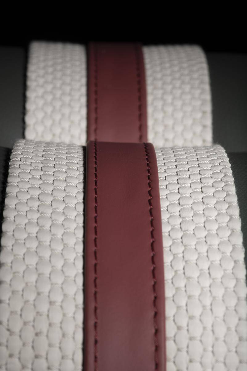 White textured belt with a red leather band at the top in the middle