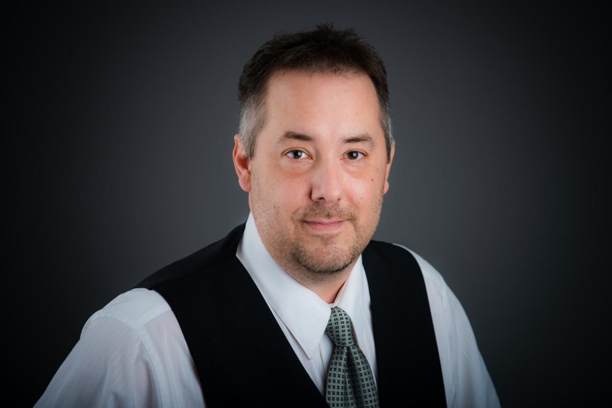 A man in a headshot for business