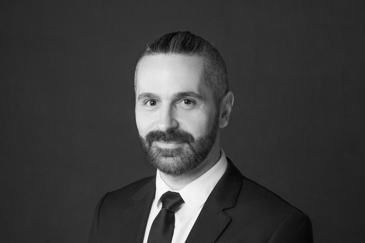 A black and white headshot of a man