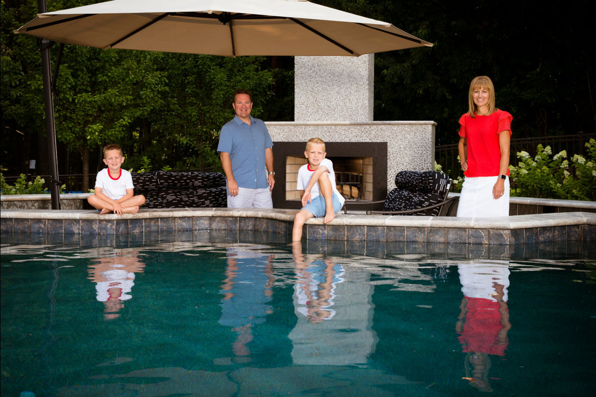 Family portrait behind pool