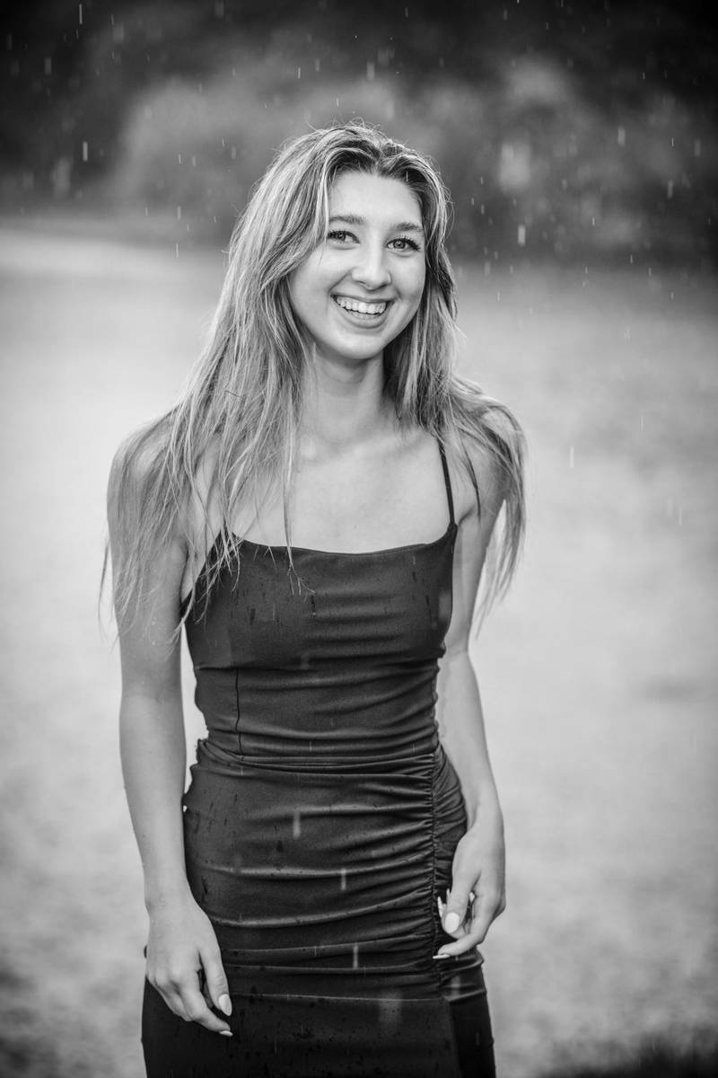 Smiling girl outside over the rain