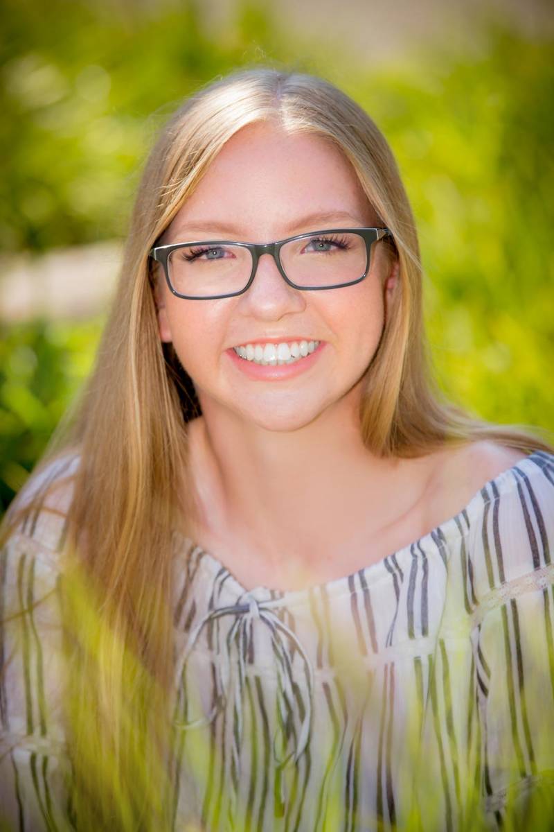 Smiling young lady with glasses