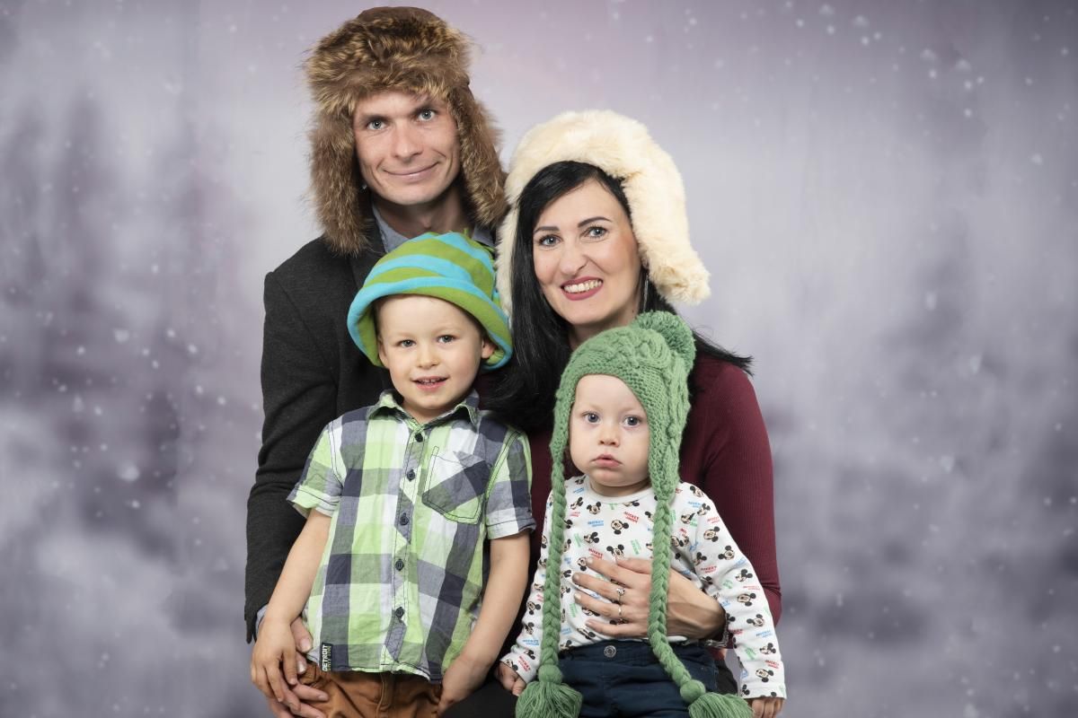 young family with two children dressed in christmas costumes
