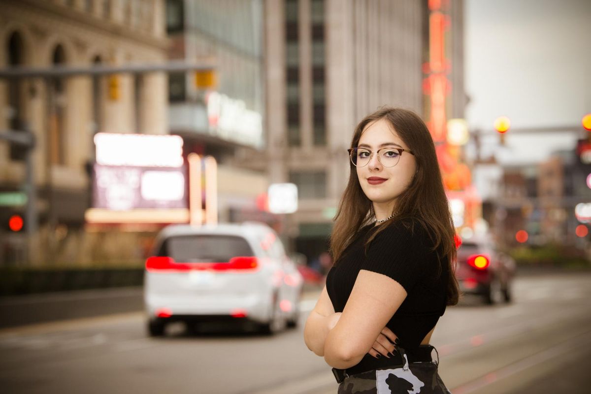 Young lady portrait on the background of Detroit downtown